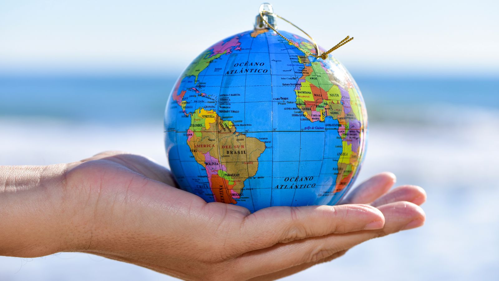 A shot of a hand holding a globe